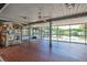 Screened-in lanai with brick flooring and panoramic water view, ideal for entertaining and relaxation at 5339 Kings Ct, Fruitland Park, FL 34731
