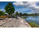 Waterfront backyard with concrete retaining wall and mature landscaping and access to the waterway at 5339 Kings Ct, Fruitland Park, FL 34731