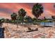 Backyard overlooking the waterfront and mature landscaping featuring a brick and gravel patio area at 5339 Kings Ct, Fruitland Park, FL 34731