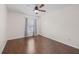 Bedroom featuring wood floors, a ceiling fan, and a bright window at 5492 Compass Pt, Oxford, FL 34484