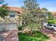 Attractive exterior elevation with brick drive, two-car garage, and mature tree at 5492 Compass Pt, Oxford, FL 34484