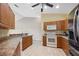Well-lit kitchen features wooden cabinets, granite countertops and stainless steel appliances at 5492 Compass Pt, Oxford, FL 34484
