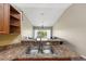 Kitchen sink looking out at living room with balcony access at 5492 Compass Pt, Oxford, FL 34484