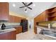 Kitchen features wooden cabinets, granite countertops and stainless steel appliances at 5492 Compass Pt, Oxford, FL 34484