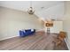 Spacious living room with hardwood floors, vaulted ceiling, chandelier, and open view of the kitchen at 5492 Compass Pt, Oxford, FL 34484