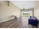 Well-lit living room with hardwood floors, neutral wall colors, and sliding glass doors with backyard view at 5492 Compass Pt, Oxford, FL 34484