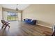 Inviting living room features hardwood floors, vaulted ceiling, chandelier, and sliding doors to outdoor balcony at 5492 Compass Pt, Oxford, FL 34484