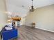 Bright and airy living room featuring high ceilings, hardwood floors, and an open layout to the kitchen at 5492 Compass Pt, Oxford, FL 34484