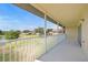 Screened patio overlooks grassy common area and a view of a pond at 5492 Compass Pt, Oxford, FL 34484
