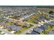 An aerial view of a residential community featuring many homes and serene ponds in a well-planned neighborhood at 560 Caputo Ct, The Villages, FL 32163
