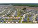 An aerial view of a large residential community featuring numerous single-Gathering homes, ponds, and green spaces at 560 Caputo Ct, The Villages, FL 32163