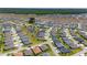 An aerial view of a planned residential community showcasing numerous homes, several ponds, and community landscaping at 560 Caputo Ct, The Villages, FL 32163