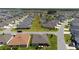Aerial view of a single-Gathering home with a screened-in porch, set within a well-maintained residential neighborhood at 560 Caputo Ct, The Villages, FL 32163