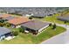 Aerial view of a single-Gathering home showcasing a screened-in porch, lush landscaping, and manicured lawn in a community at 560 Caputo Ct, The Villages, FL 32163