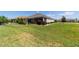 Expansive backyard featuring well-maintained lawn and lush landscaping, creating a private outdoor space at 560 Caputo Ct, The Villages, FL 32163