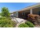 Well-maintained backyard with lush landscaping, outdoor seating, and a screened-in patio at 560 Caputo Ct, The Villages, FL 32163