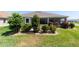 Landscaped backyard with mature trees and shrubs, offering a serene and private outdoor retreat at 560 Caputo Ct, The Villages, FL 32163