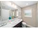 Bright bathroom with a large mirror, a single sink vanity and a glass door shower at 560 Caputo Ct, The Villages, FL 32163