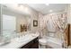 Bright bathroom features a shower and tub combo with a neutral color palette at 560 Caputo Ct, The Villages, FL 32163