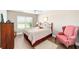 Comfortable bedroom showcasing a ceiling fan, wood-style floors, and natural light at 560 Caputo Ct, The Villages, FL 32163