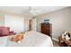 Bright bedroom features a ceiling fan, closet, and a cozy area with decor at 560 Caputo Ct, The Villages, FL 32163