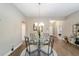 Cozy dining area features a modern chandelier and views into other living spaces at 560 Caputo Ct, The Villages, FL 32163