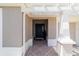 Welcoming front entrance features a decorative door and a textured concrete landing at 560 Caputo Ct, The Villages, FL 32163