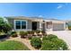 Well-maintained single-story home featuring manicured landscaping and a spacious driveway at 560 Caputo Ct, The Villages, FL 32163
