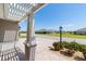 Covered front porch with patterned concrete and view of the well-maintained neighborhood at 560 Caputo Ct, The Villages, FL 32163