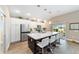 Modern kitchen features an island with seating, stainless steel appliances, and ample storage at 560 Caputo Ct, The Villages, FL 32163