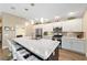 Bright kitchen featuring an oversized island with seating and stainless steel appliances at 560 Caputo Ct, The Villages, FL 32163