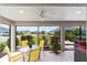 Inviting lanai with seating area and serene views of the landscaped backyard at 560 Caputo Ct, The Villages, FL 32163