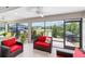 Screened-in lanai with comfortable seating provides views of the outdoors at 560 Caputo Ct, The Villages, FL 32163