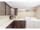 Functional laundry room equipped with washer, dryer, sink, and ample counter space at 560 Caputo Ct, The Villages, FL 32163
