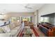 Open living room showcases sliding glass doors, wood flooring, and a ceiling fan at 560 Caputo Ct, The Villages, FL 32163