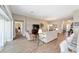 Large open-plan living space with tile floors, offering versatility and natural light at 560 Caputo Ct, The Villages, FL 32163