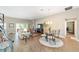 Open-concept living space featuring tile floors and an adjacent dining area at 560 Caputo Ct, The Villages, FL 32163