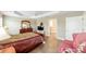 Bright main bedroom boasts wood floors, recessed lighting, and a spacious closet at 560 Caputo Ct, The Villages, FL 32163