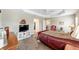 Primary bedroom features wood floors, a ceiling fan, and a spacious walk-in closet at 560 Caputo Ct, The Villages, FL 32163
