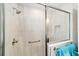 Modern shower design with grab bar, bench, and a tiled wall at 560 Caputo Ct, The Villages, FL 32163