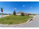Corner lot featuring a well-maintained lawn and shrubbery with a view of neighboring homes at 560 Caputo Ct, The Villages, FL 32163