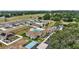 Aerial view of community clubhouse, swimming pool, tennis courts, and parking area at 579 Juniper Way, Tavares, FL 32778