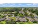A quiet community featuring sprawling lawns, lush trees, and a peaceful lake at 579 Juniper Way, Tavares, FL 32778