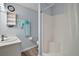 Bright bathroom has a sink, toilet, walk-in shower, storage shelf, and modern fixtures at 579 Juniper Way, Tavares, FL 32778