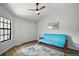 Bedroom featuring a futon, ceiling fan, window and closet with a wood floor at 579 Juniper Way, Tavares, FL 32778