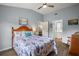 Bedroom offers a beach-themed decor, wood floor, ceiling fan, and access to the bathroom and other rooms at 579 Juniper Way, Tavares, FL 32778