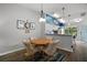 Cozy dining area with a table, four chairs, wood flooring, and decor at 579 Juniper Way, Tavares, FL 32778