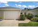 A well-maintained home with a one-car garage, manicured landscaping, and a clean driveway at 579 Juniper Way, Tavares, FL 32778