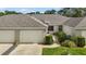 Charming home with a one-car garage, neat landscaping, and a welcoming pathway at 579 Juniper Way, Tavares, FL 32778