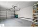 Spacious two car garage with neutral paint, overhead storage and room for vehicle parking at 579 Juniper Way, Tavares, FL 32778